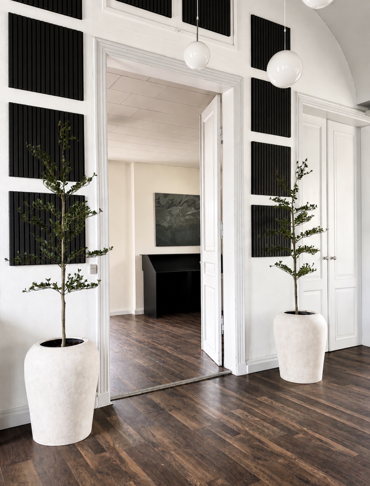 Indgang til Under Hatten med dobbeltdøre og store planter